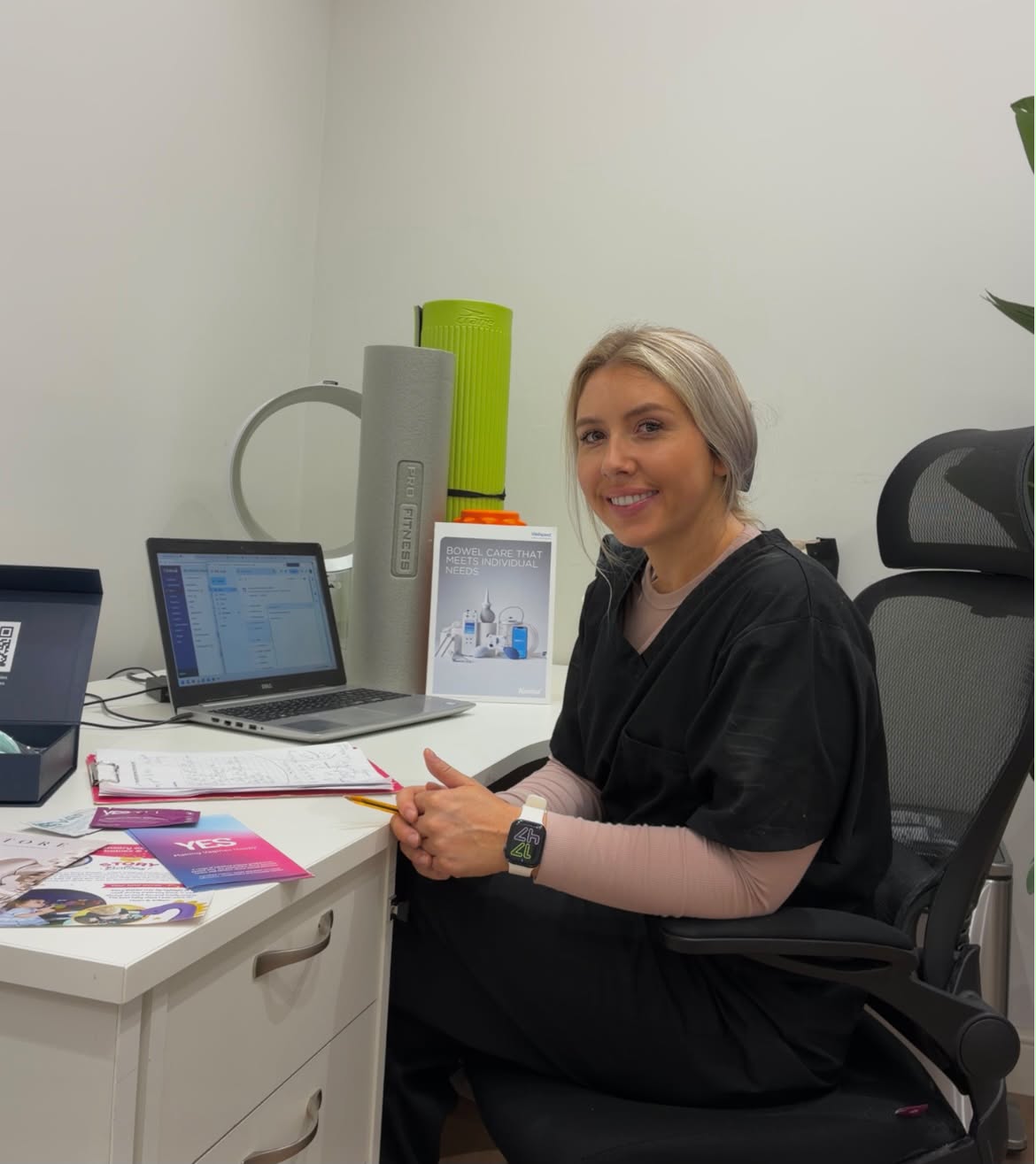 Milly Watts, pelvic health physiotherapist, at her clinic desk